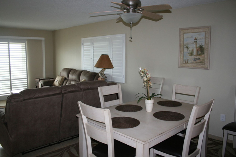 white dining table and chairs with brown accent