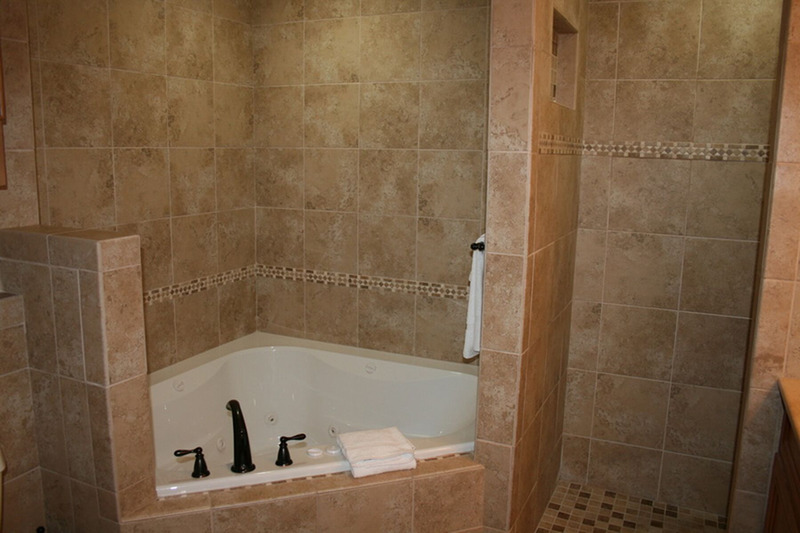 large bathroom with large tub with jets 