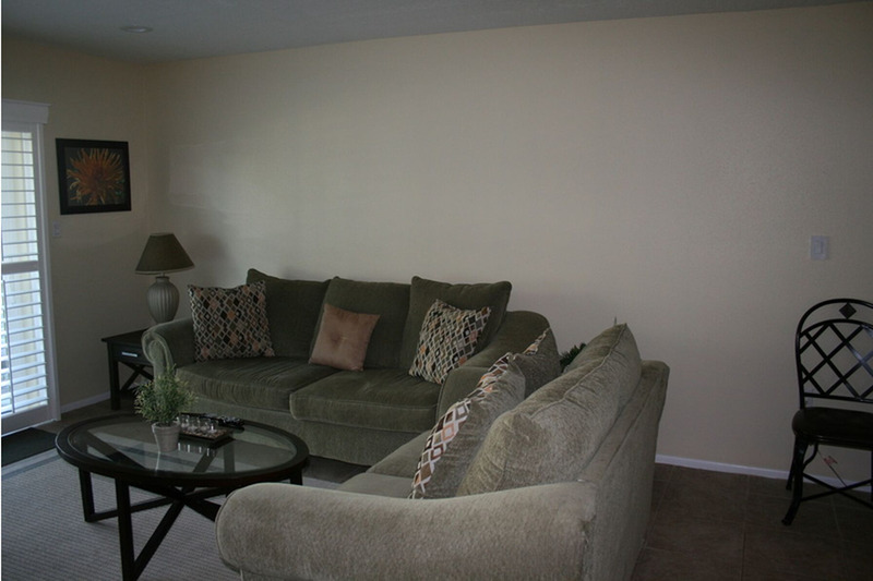 two couches in the form of an L facing a glass table 