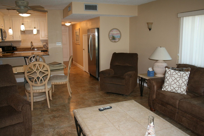 furnished living area with dining table, living room, and kitchen