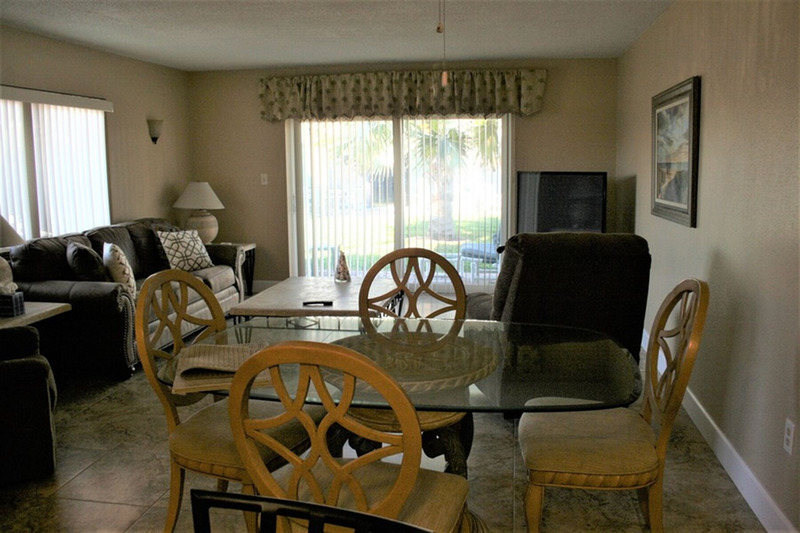 furnished living area with dining table, living room, and kitchen
