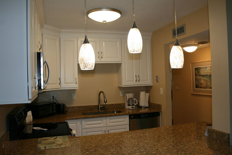 kitchen with lots of lighting and white cabinets