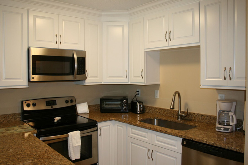 kitchen with lots of lighting and white cabinets