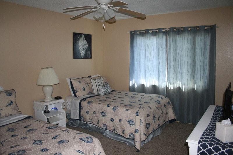 two twin beds in a spare bedroom separated by a lamp