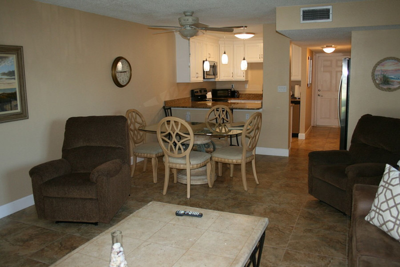 furnished living area with dining table, living room, and kitchen