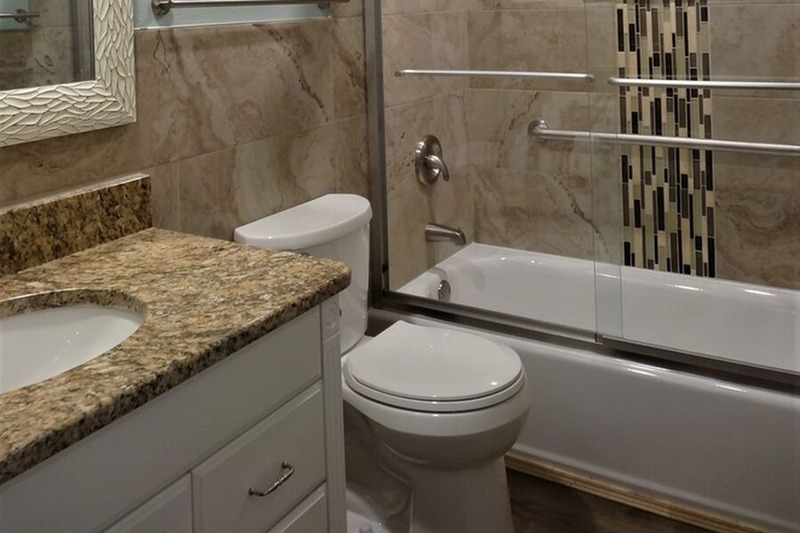 bathroom with a walk in tub shower