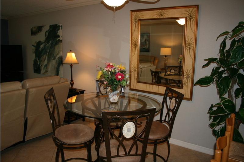 dim light over a three person glass dining table
