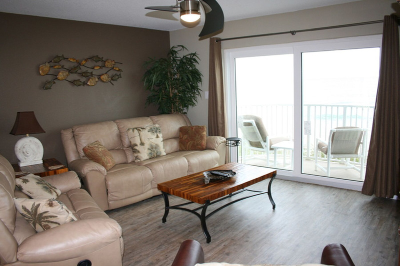 beige colored furnished living room with large glass sliding door