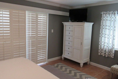 Master bedroom with armoire and open wrap around balcony 