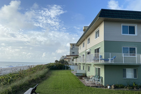 villa buildings and ocean with a bright blue sky