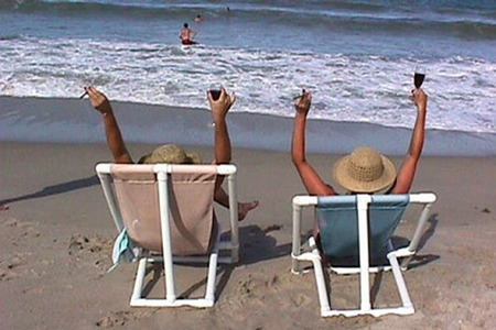 couple enjoying beach with cocktails