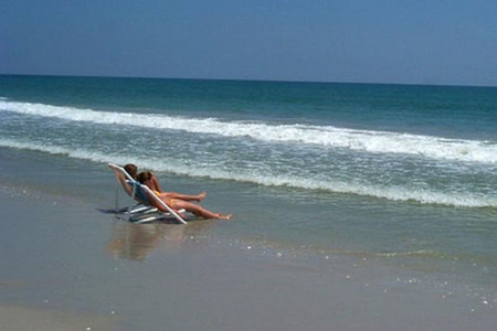 2 people relaxing in chairs at ocean edge