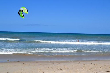 flying a kite at the ocean