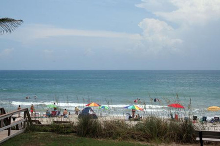 Melbourne Beach with people and umbrellas