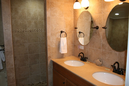 large bathroom with two sinks and aesthetically pleasing mirrors