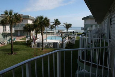pool view with the ocean behind it seen from the balcony