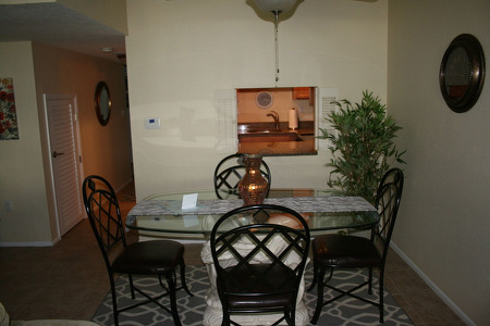 dining table with 4 seats around a glass table