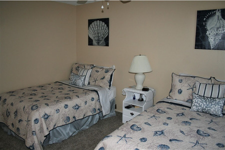two twin beds in a spare bedroom separated by a lamp