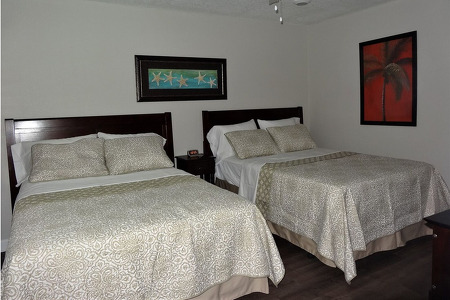 two beds taking up the majority of the bedroom