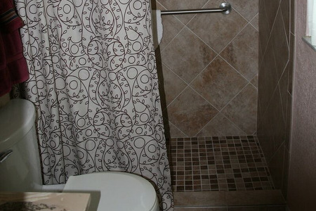 walk in shower with checkered floor