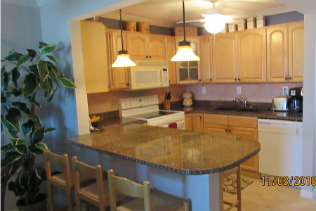 large kitchen with seats on the other side of the countertop