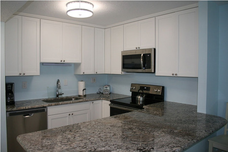 marble kitchen counter with white cabinets