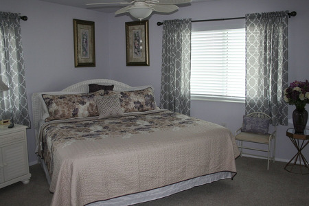 large king size bed with beige sheets and comforter